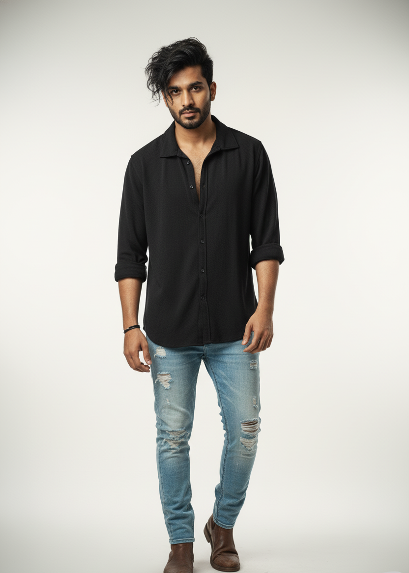Man wearing a black shirt and light blue jeans on a white background